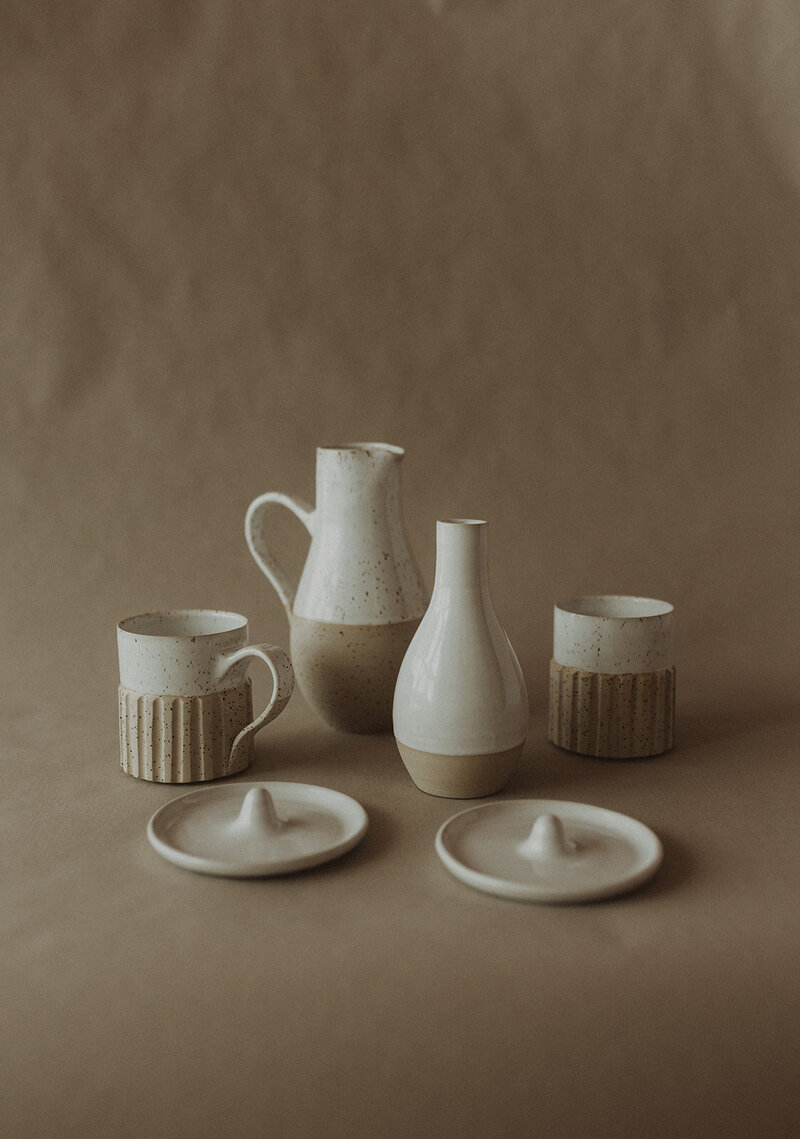 Product photo of handmade pottery items such as a cup and jug.