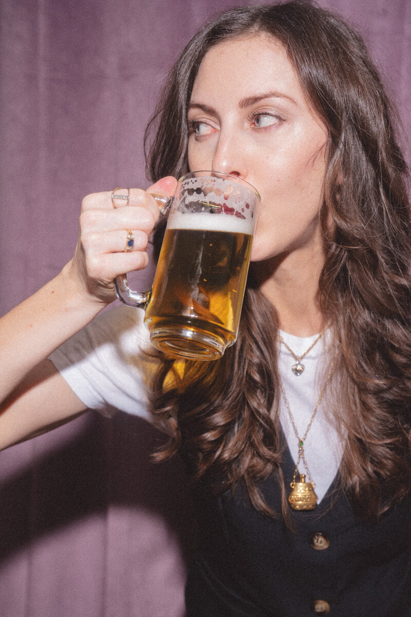 Photo of Cassie drinking a draft - a nod to the Draft House, her copy coaching membership - Mettle & Tonic