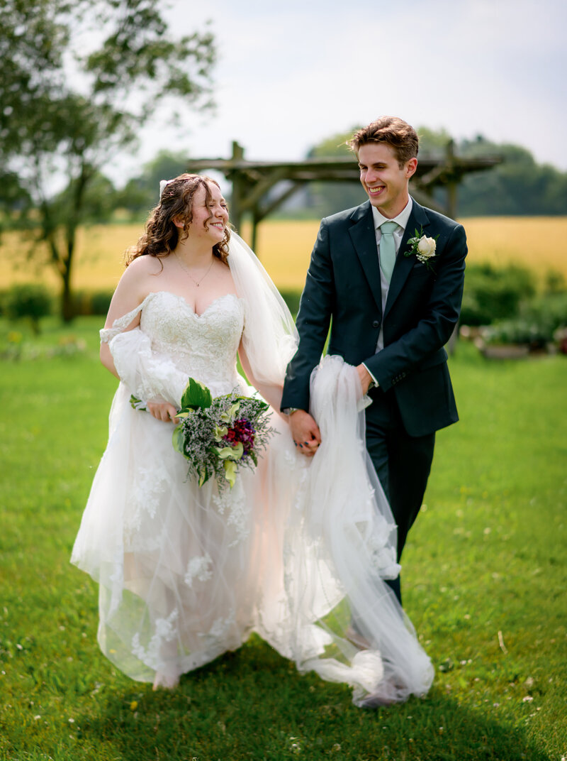 Bride and groom laughing during  wedding photos in St.Jacobs, Ontario.