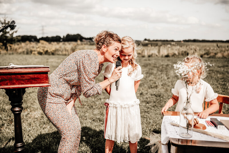 Ceremoniespreker Jolien spreekt met liefde spreekt tijdens buitenceremonie en betrekt kinderen.