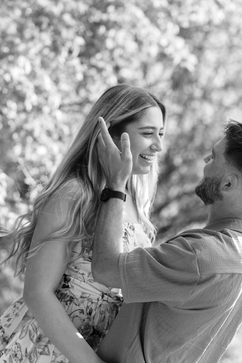 Close-up of a couple gently holding each other’s faces, sharing a tender and emotional moment that captures their deep connection and love.