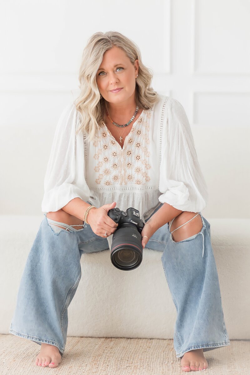 Angela Rae, Lake Norman family photographer, smiling at camera with camera in hand