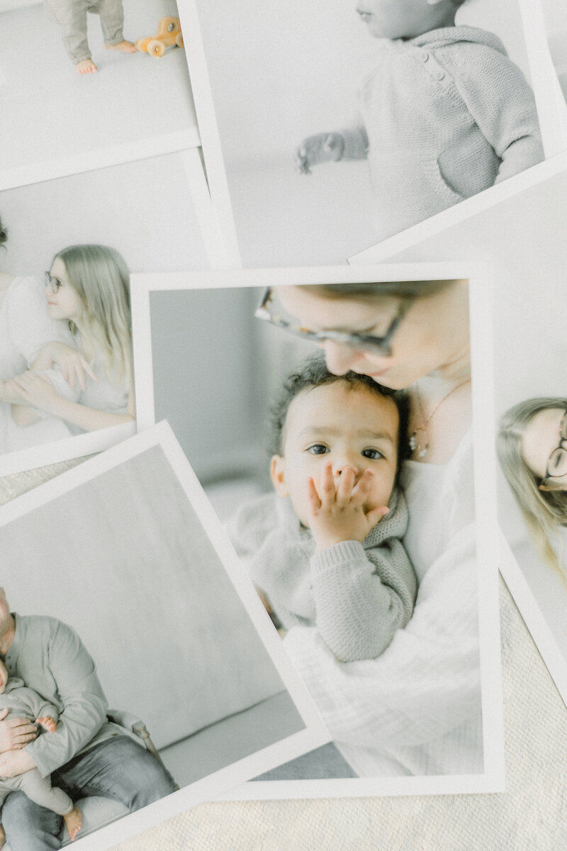 A pile of printed portrait photos taken of Dallas Fort Worth families.