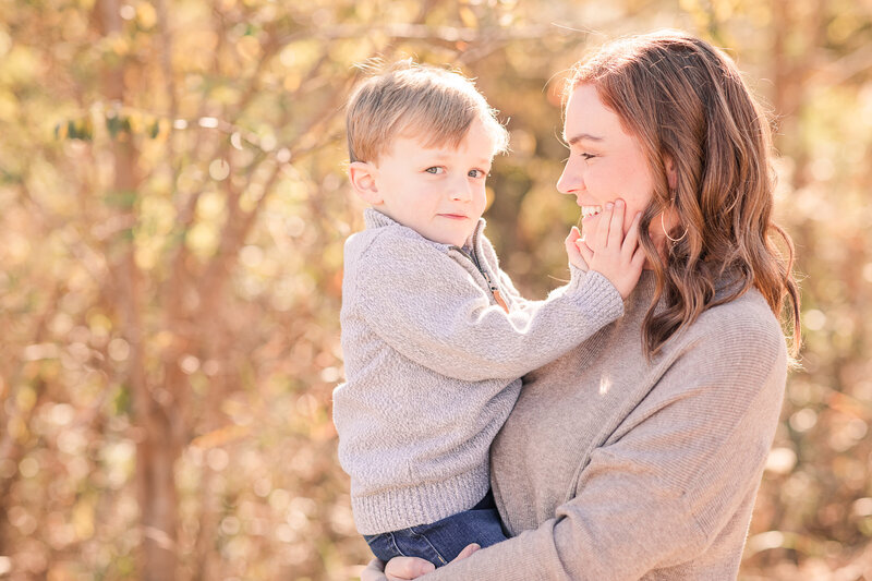 son squeezing mom's face