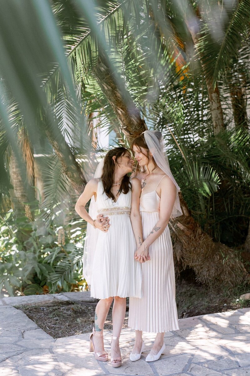 Bride and groom sit and embrace on their wedding day at Belmond El Canto