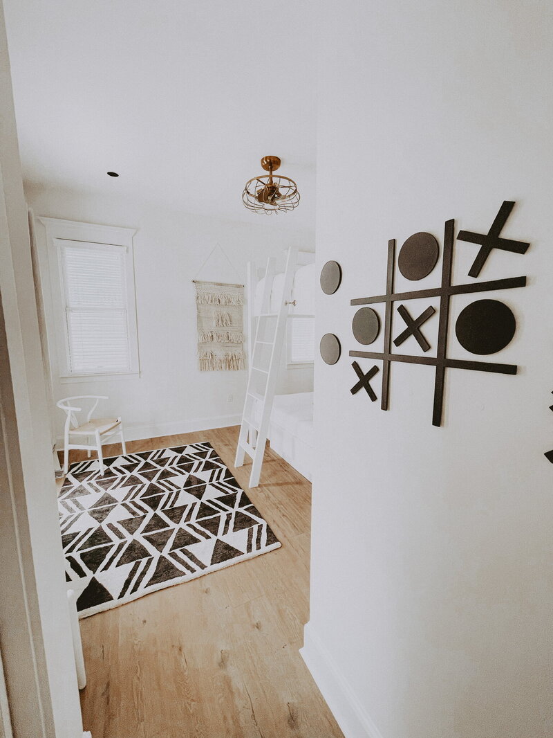 white bunk bed with black accent rug