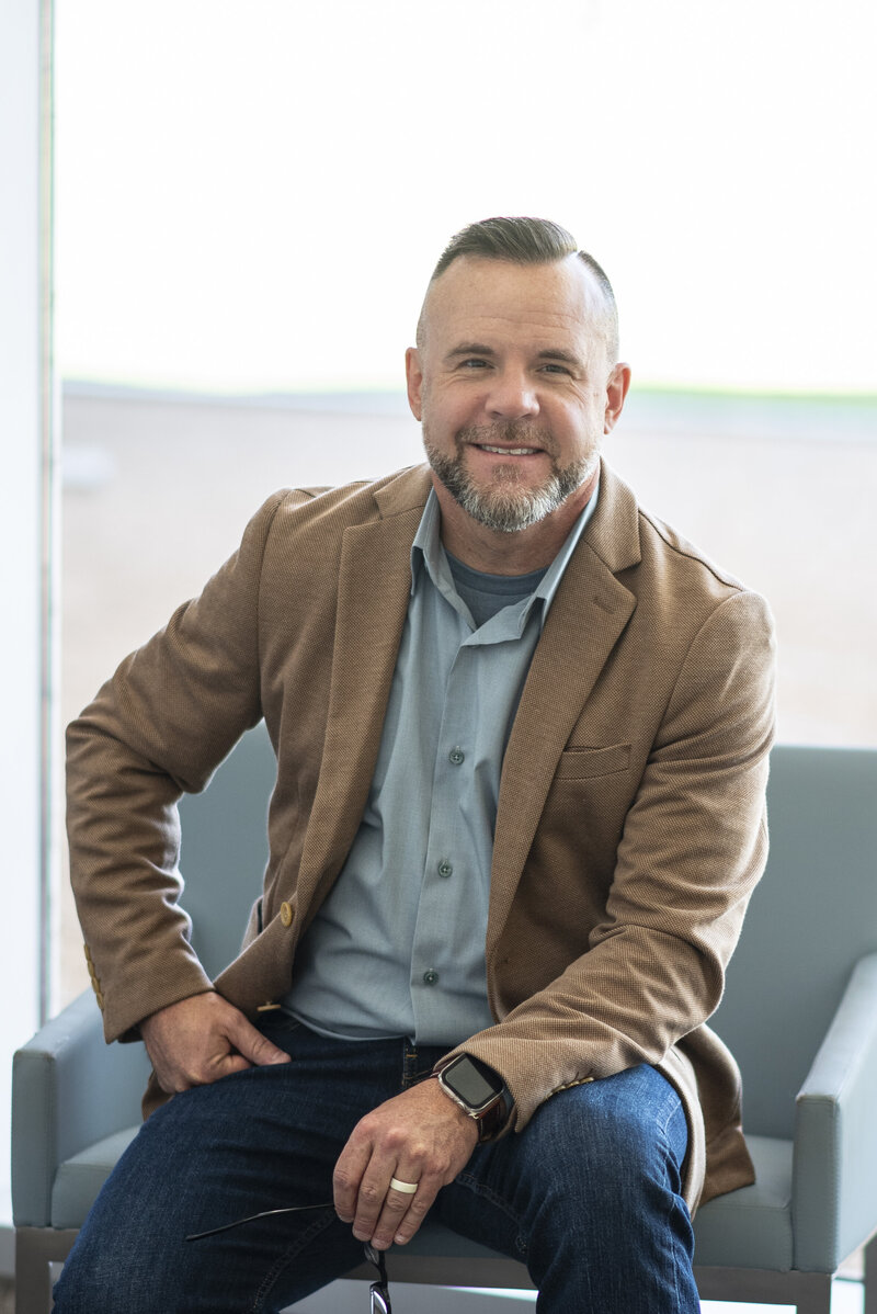 Photo of Matt Kidwell sitting in a professional office