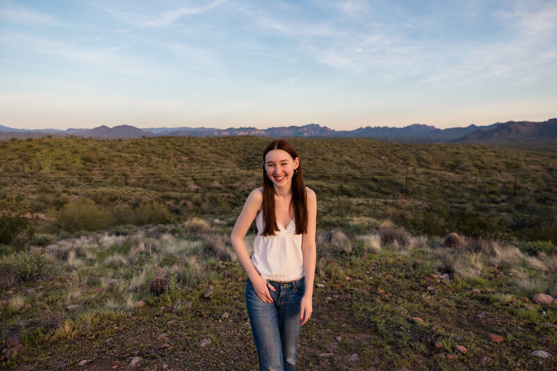 high school graduate laughing in desert