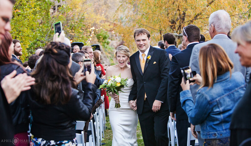 Couple walks down the aisle at their riverside wedding ceremony at Wedgewood Weddings at Boulder Creek