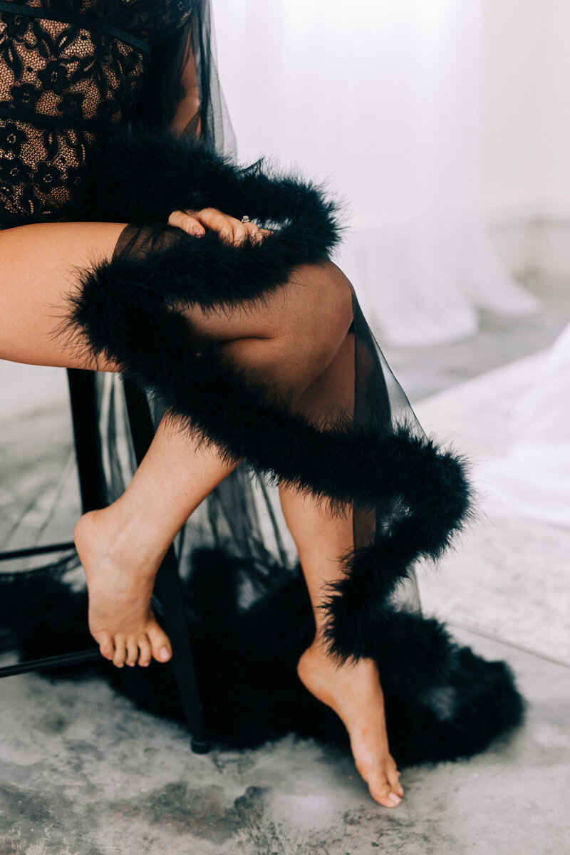 Detail shot of womans feet with feathery robe | boudoir session with Winx Photo