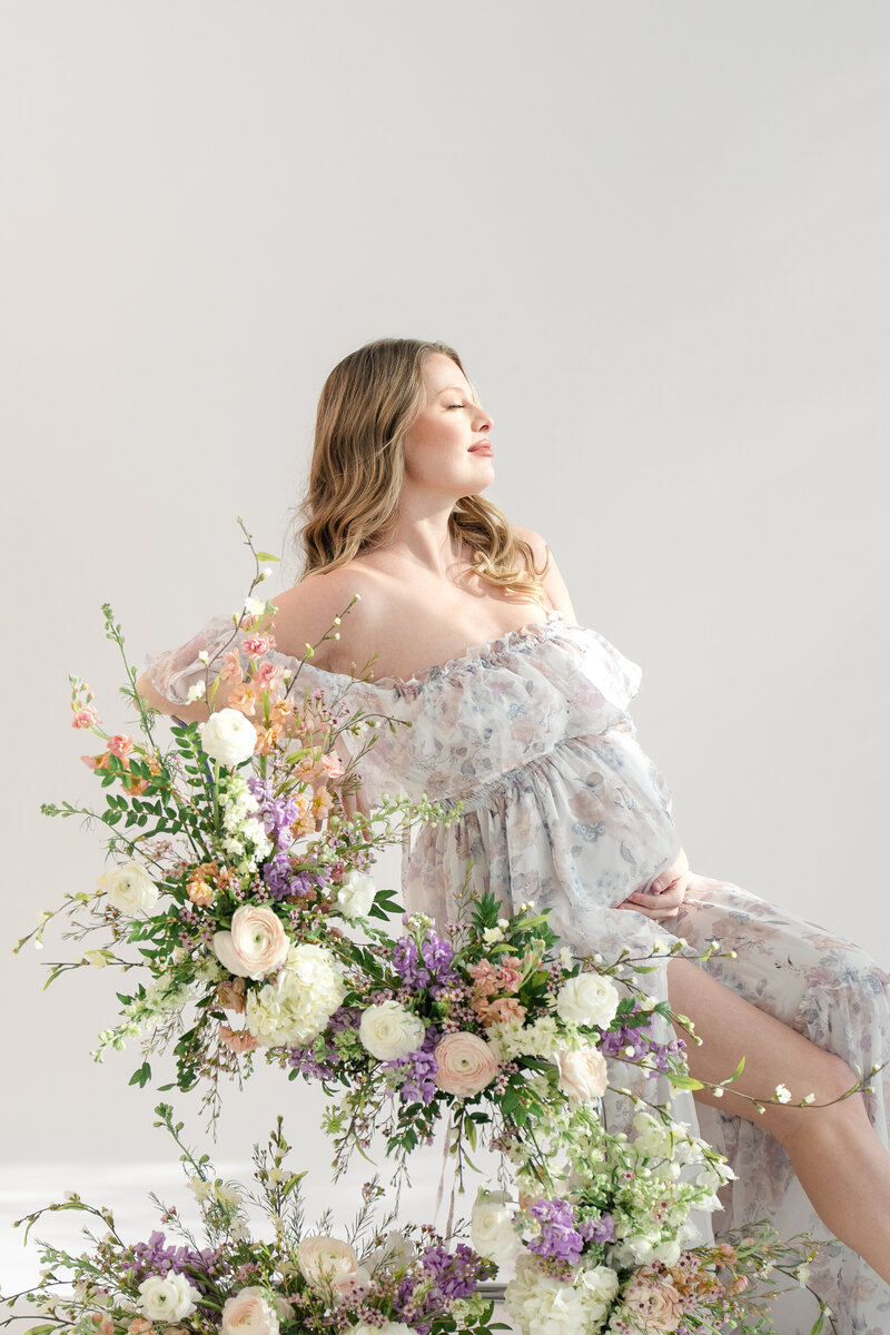 In-studio Maternity Session with floor floral arrangments for mother's day minis photoshoot