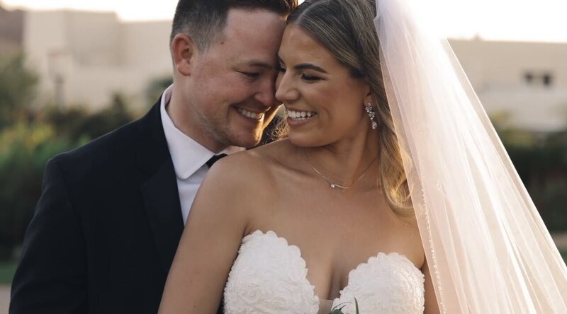 still from california wedding video bride and groom embracing on. beach