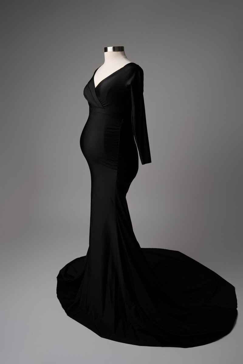 Form-fitting off-shoulder black dress with structured waist detail