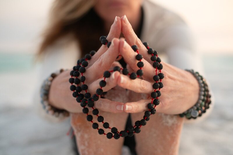 Stephanie holding mala beads 