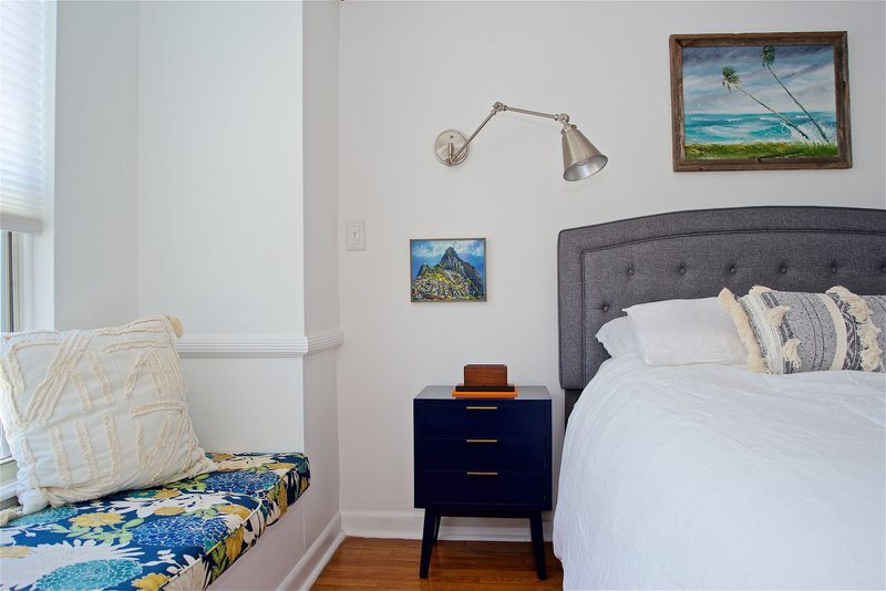 A bright blue and white coastal design in this midcentury modern bedroom by Denver based interior designer Fernway & Avalon