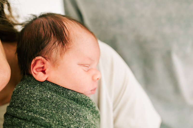 newborn pictures in Springfield Mo of side profile of newborn baby sleeping on mom's shoulder