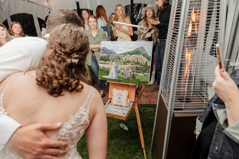 Hartly and her husband's happy reaction to seeing their live wedding painting completed