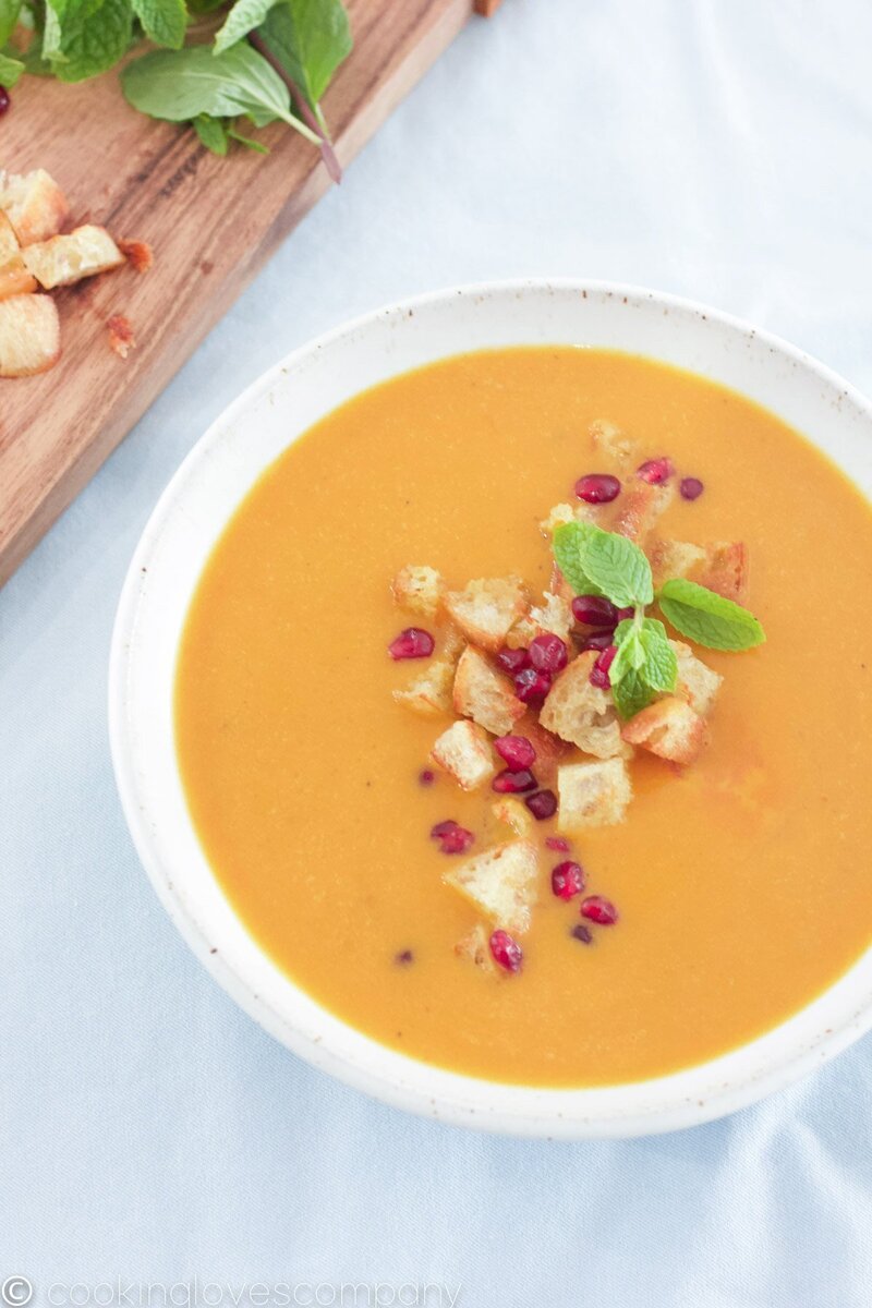 Picture of a pumpking curry soup on a white countertop