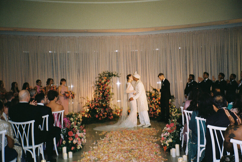 Bridesmaids see the Bride for the fist time and are smiling