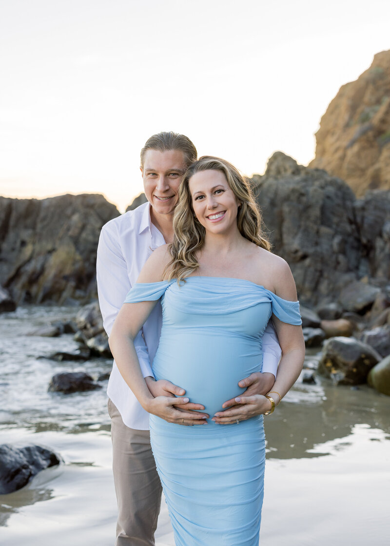 smiling maternity picture on the beach