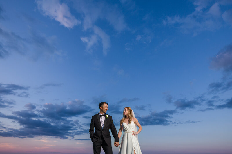 Couple at blue hour at the Blue Mountain lookout, with only the expansive sky behind them, creating a serene wedding moment.