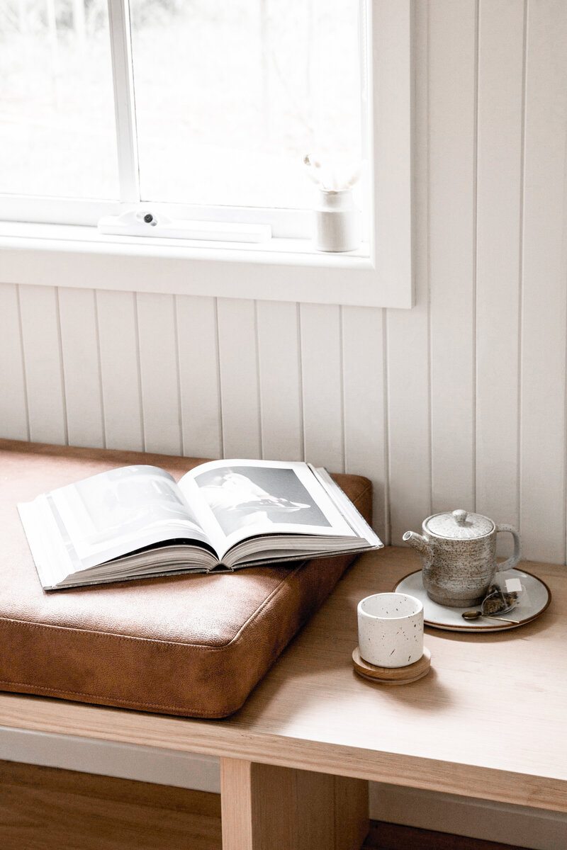 White Room with bench with photography book and tea pot