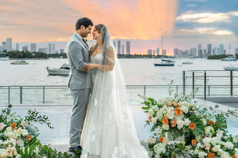 Bride and groom sharing a romantic moment during sunset at the Mondrian South Beach Miami, photographed by White House Wedding Photography.