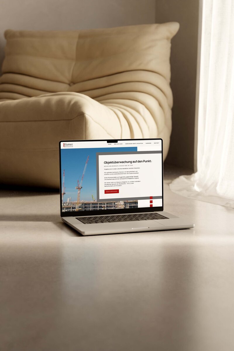 MacBook with open website in browser on the ground