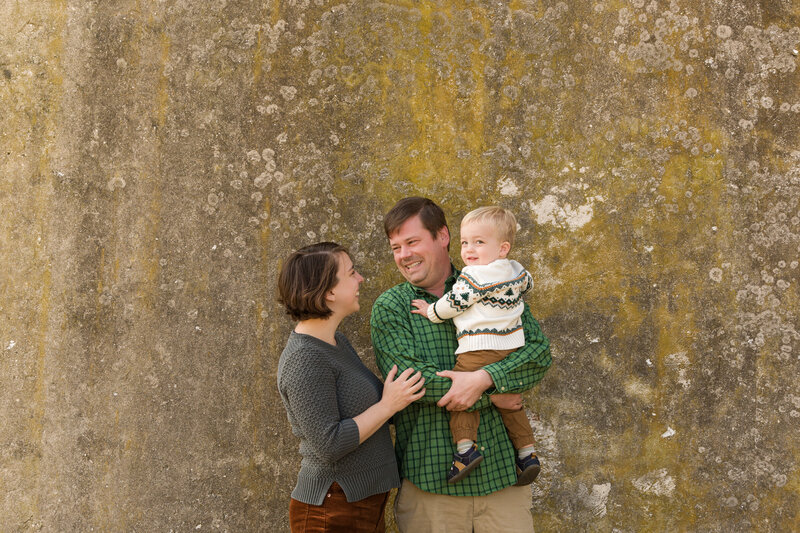 A mom, dad, and their son bursting into laughter together, photographed during a lighthearted mini session in King of Prussia