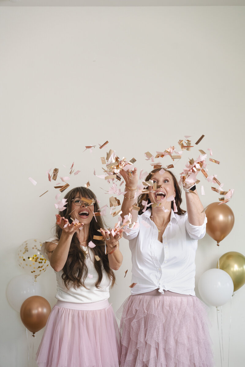 women-with-balloons-throwing-confetti-for-brand-photos