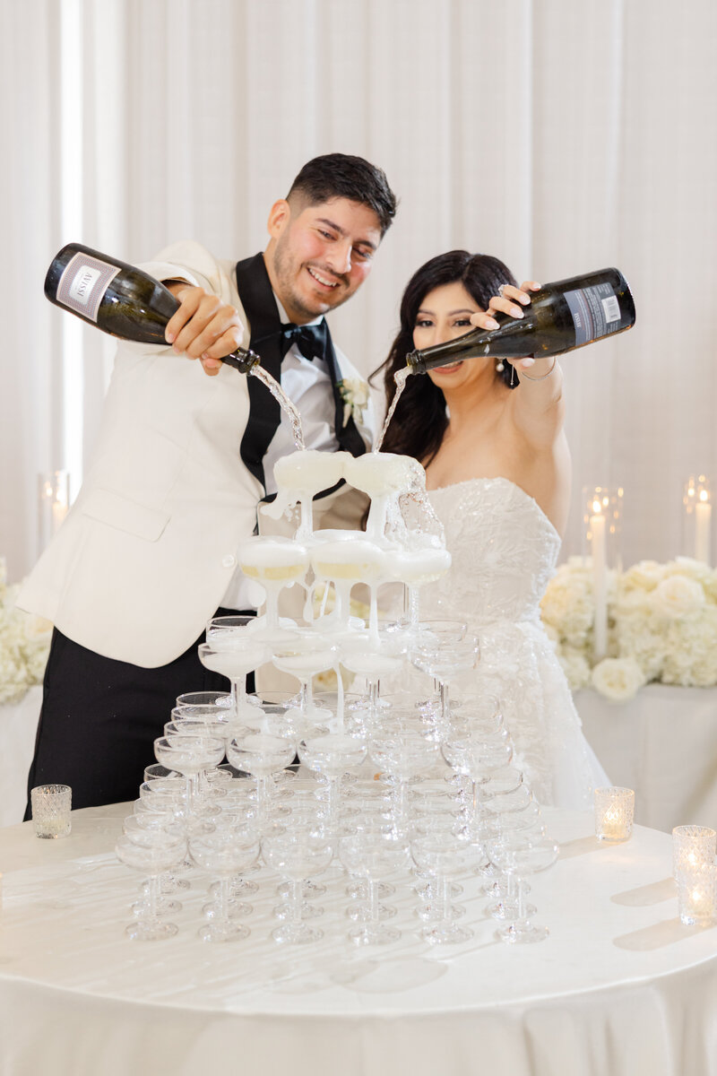 Bride and Groom with a Champagne tower; photo by Chicago wedding photographer Winterlyn Stebner