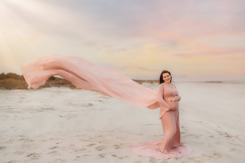Expectant mother poses for Maternity Pictures during Maternity Photoshoot on Folly Beach in Charleston, SC.