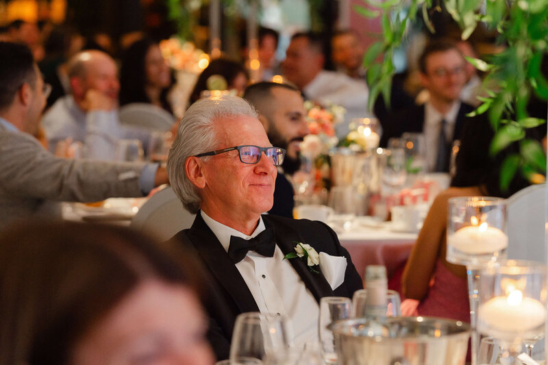 Ottawa wedding photography showing a father of the groom looking adoringly at his son as he gives his speech during his Chateau Le Parc reception