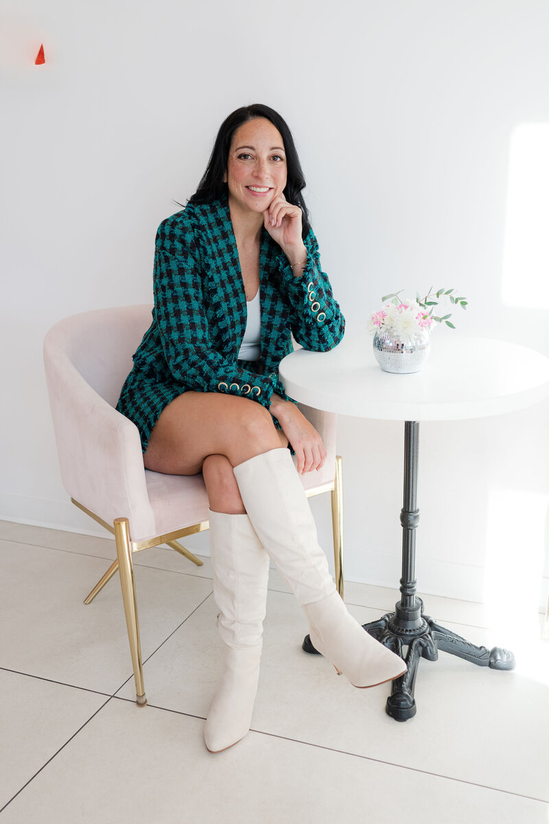 Woman sales professional sitting in modern chair and leaning on table
