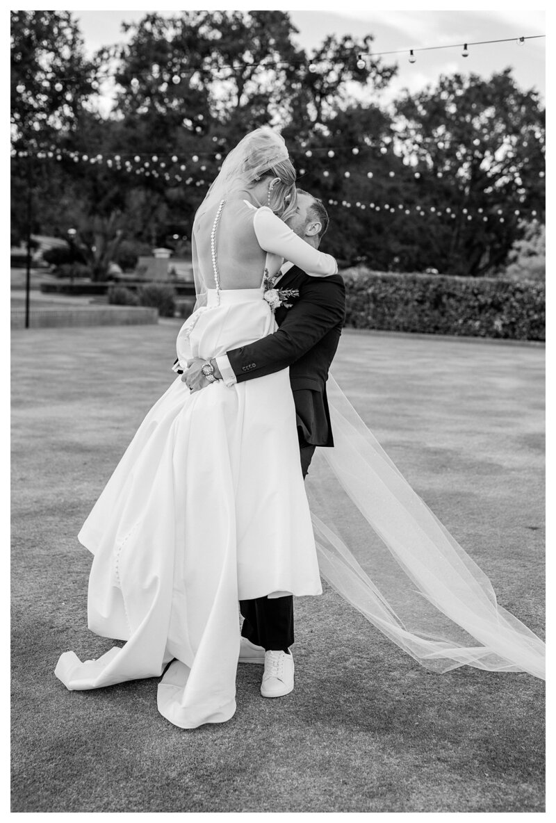 Bride and groom embracing in a candid wedding photo at their luxury ballroom wedding.