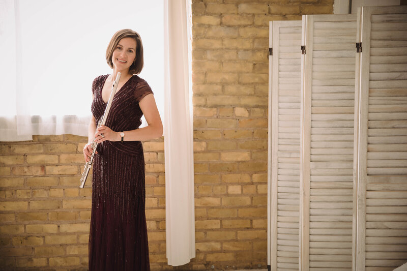 Sarah Weisbrod, Flutist & Teaching Artist, Standing and Holding Flute in a Purple Dress