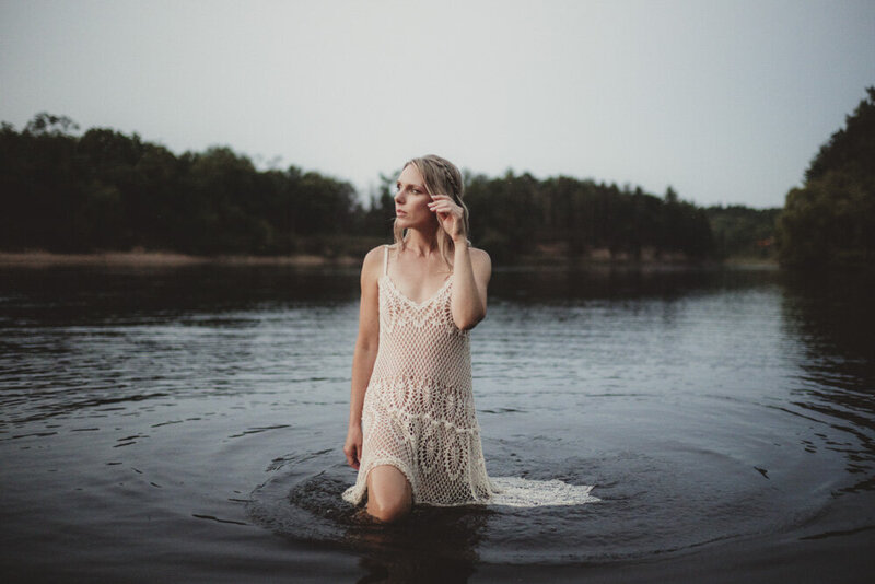 Caroline immersed in gentle waves, representing release, renewal, and spiritual clarity.