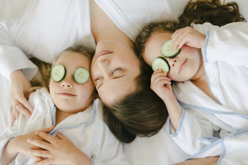Creative spa day session with mom and two daughters doing a facial- captured by Amy Marie photography