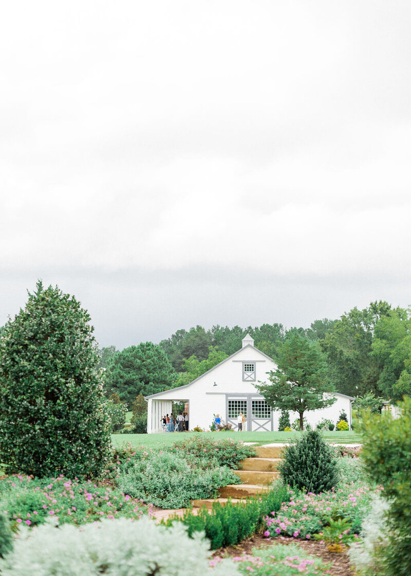 white barn wedding venue in NC with gardens and lake