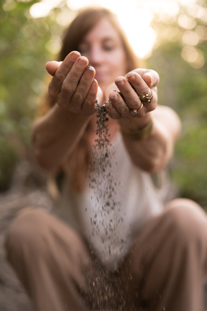 yoga teacher releasing dirt from her hands