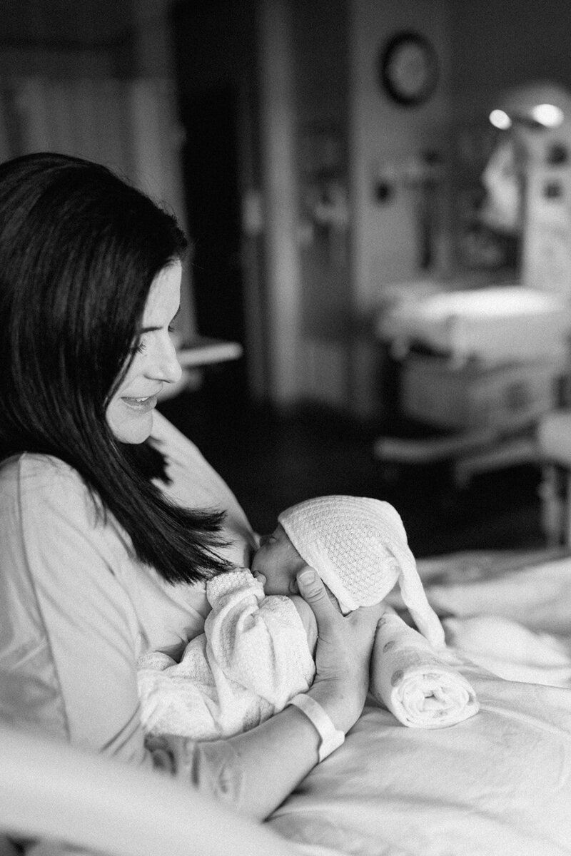 New mom breastfeeding baby in hospital