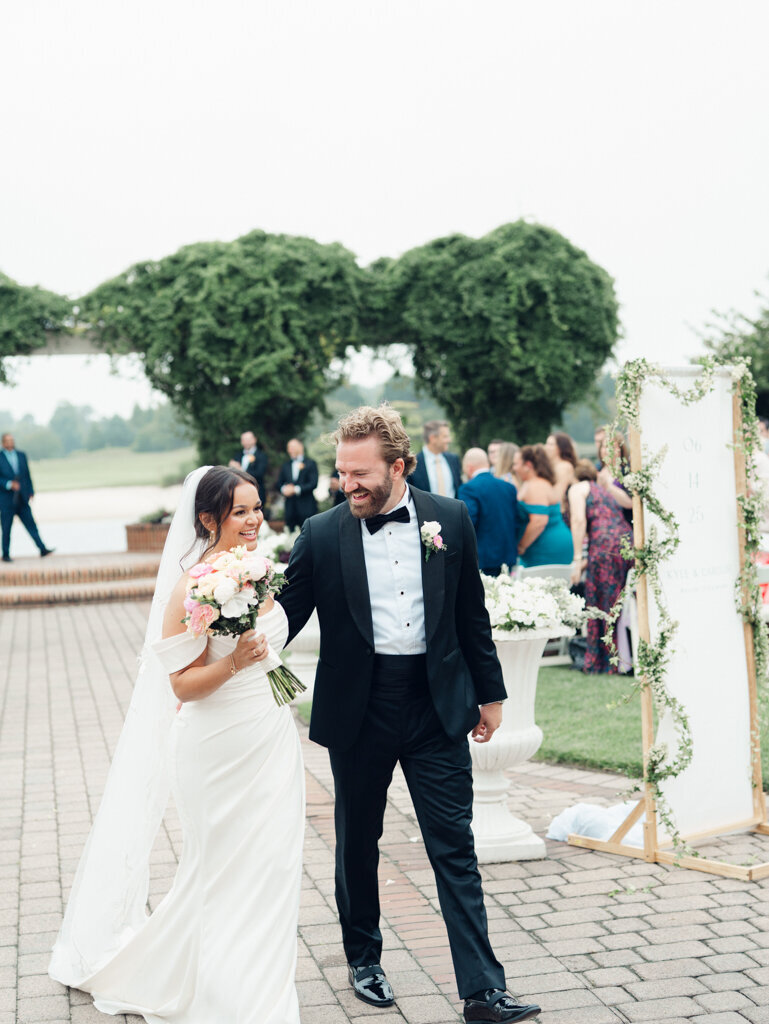 Couple walking out of their ceremony taken by baltimore wedding photographer, Nicole Simensky
