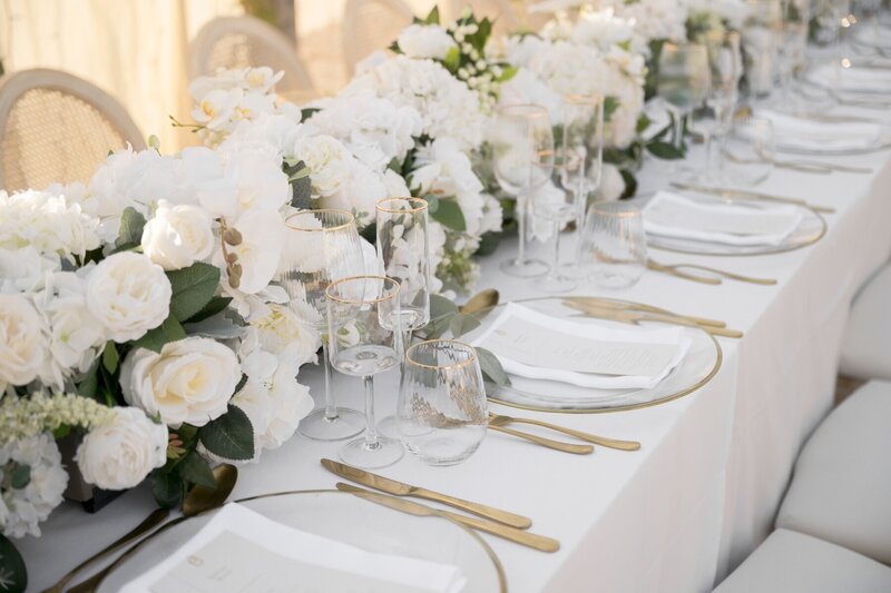 Luxury wedding reception table with white rose floral garland