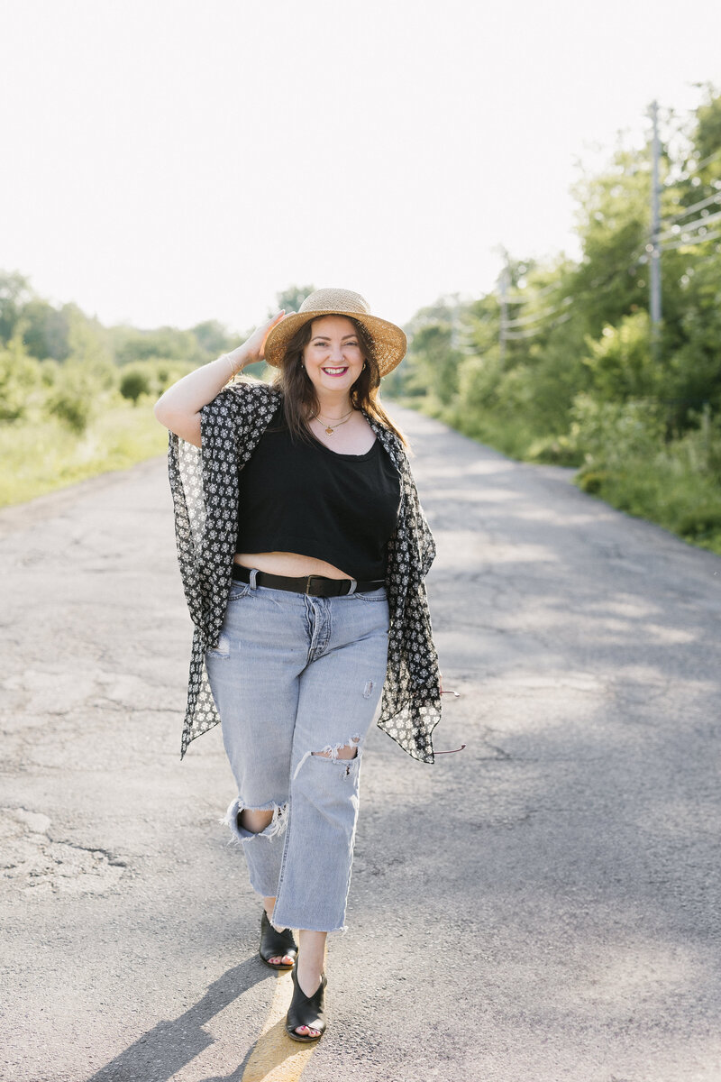 A street branding photography session with a woman in casual wear and a sun hat