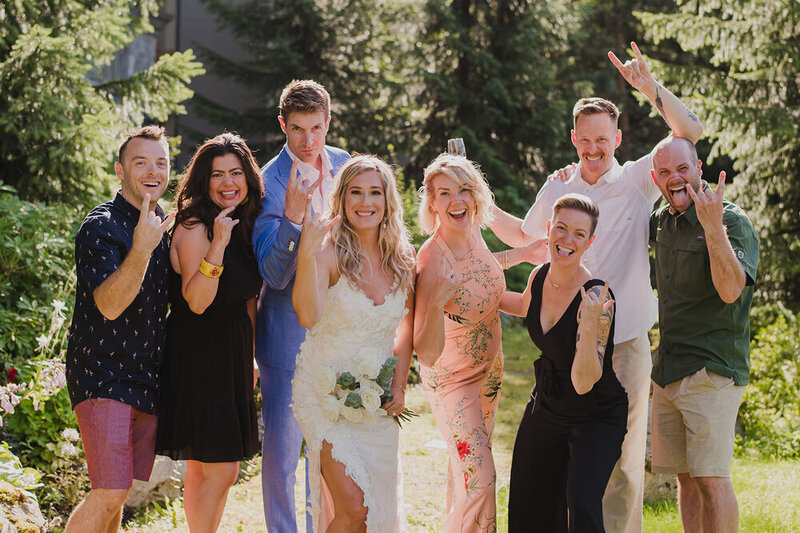 Group of people smiling and posing at wedding rehearsal