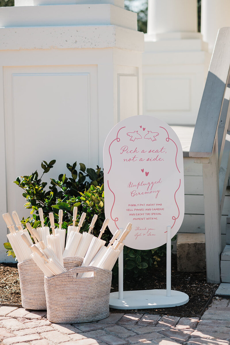 Bride in off-the-shoulder lace wedding gown twirling in a light-filled venue, surrounded by romantic floral decor designed by Eventive Designs in Austin, Texas.

