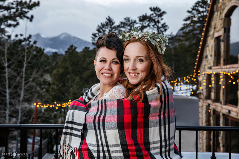 Two brides snuggle at their winter wedding at Della Terra in Estes Park