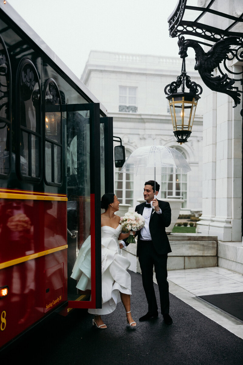 Vermont Wedding Photographer | Sincerely Liz Photography Documentary Wedding, Engagement, Elopement, Maternity and Newborn Photographer in New England | Bride gets out of train while groom holds an umbrella at a New England mansion wedding