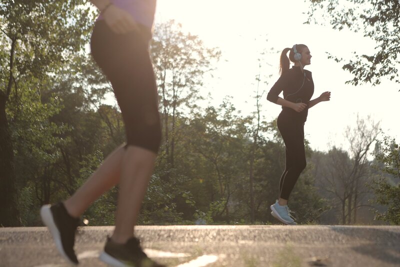 a woman with a high ponytail running up stairs