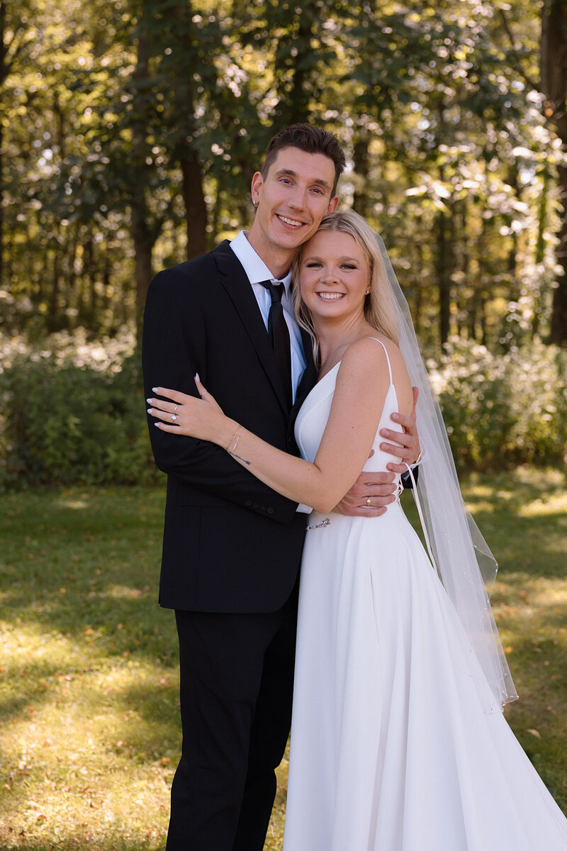 bride and groom embracing and sharing a smile 